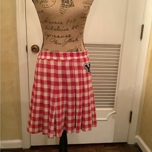 Collage style red and white pleated skirt with the letter Y